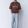 Ριγέ πλεκτό Polo shirt με φερμουάρ